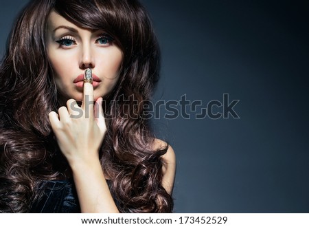 beautiful woman with finger on lips