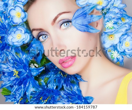 blue flowers in hair of a woman close up picture