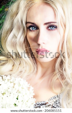 blond girl with flowers in the park