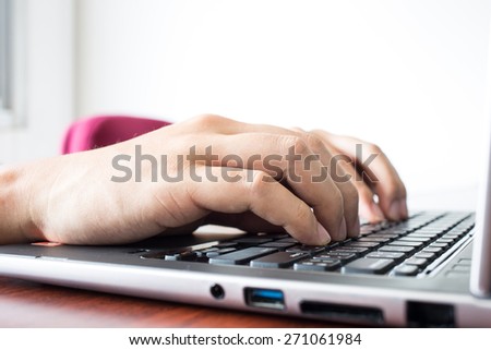 Hand typing on the keyboard.
