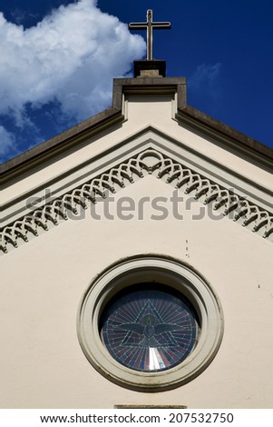 abbiate cross church varese italy the old rose window   and mosaic wall in the sky sunny day