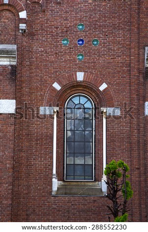 italy  lombardy     in  the  cardano campo    old   church   closed brick tower   wall rose   window tile
