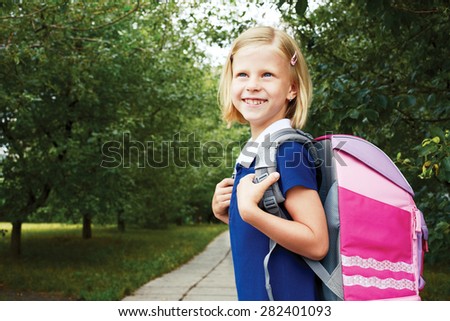 Schoolgirl goes to school with school bag.