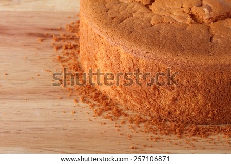 part of fresh baked cake on wood table
