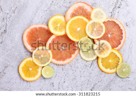 Citrus fruits cut background- oranges, lemons, limes, grapefruit