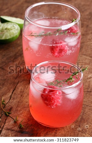 raspberry cocktail in a glass on wooden background