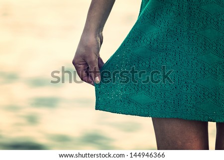 Girl with green dress with sea on background