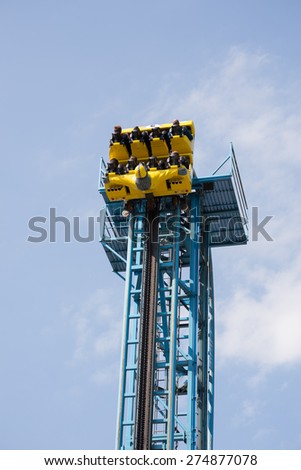 Tower and wagon with people of a rollercoaster before a free fall