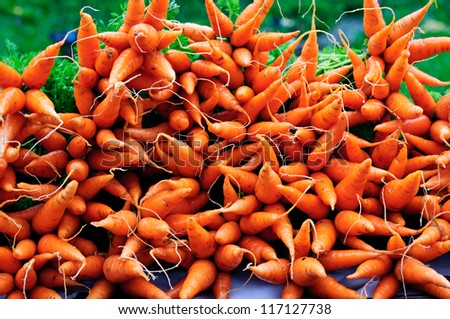Many ripe fresh raw orange carrot on a table.  Natural vegetable displayed on street for sale in Munnar Kerala India