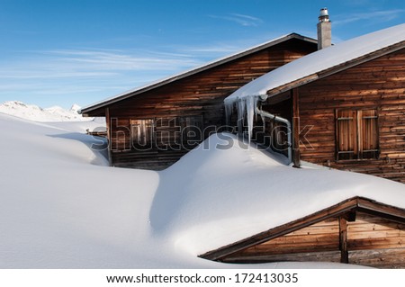 winter in Switzerland with snow covered mountains. House covered with snow. Beautiful  house. Romantic holiday house. Apartment. Home sweet home. House at mountain top.
