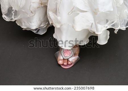 Long white gown for flower girl wedding. kid wearing beautiful barbie doll princess shoe with diamond like pink stone