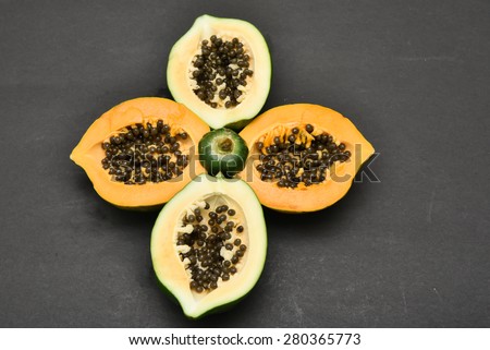 whole and a half ripe papaya.  Fresh papaya fruit. Natural facial mask.