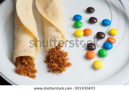 pancakes, rolled filled with shredded coconut flakes miked with sweet. egg roll confectionery sweet snacks of Kerala India. tasty food made of rice or wheat rolled.