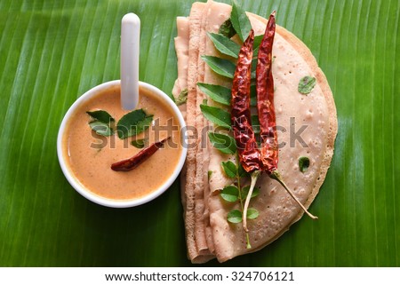 Wheat Dosa/ goduma dosa Chilli, curry leaf top view. Low fat South Indian dish best with coconut chutney. Easy make meal for breakfast use whole wheat in Andhra Pradesh, Karnataka, Tamil nadu, Kerala