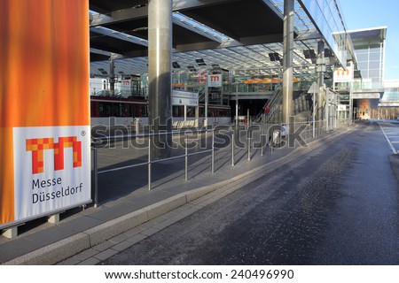 DUSSELDORF, GERMANY - JANUARY 12, 2014: Street view of tram station at Dusseldorf trade fair north entrance with a large logo banner on January 12, 2014 in Dusseldorf.