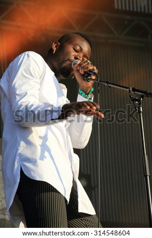 HAMBURG, GERMANY - AUGUST 23, 2015: Alloysious Massaquoi of Mercury Prize winner trio Young Fathers on stage at MS Dockville Festival on August 23, 2015 in Hamburg.