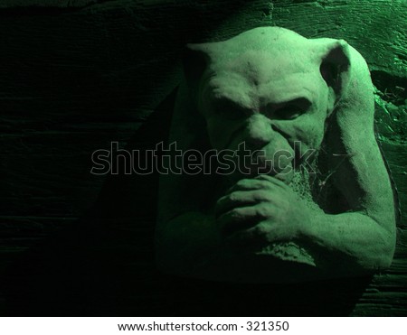 Gargoyle figure with green lighting effect
