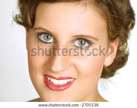 Closeup of smiling young woman against plain background