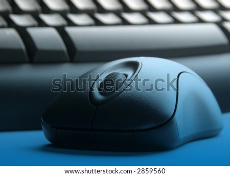 Close-up of mouse and keyboard with blue light effect.