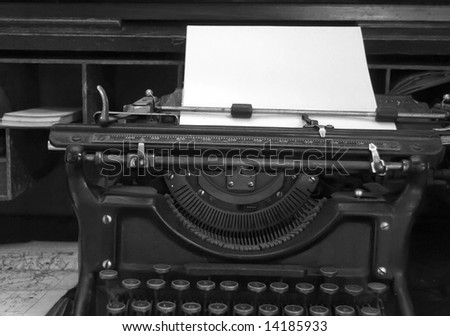 Black and white image of old typewriter and desk