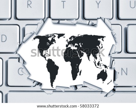 Torn hole in computer keyboard revealing world map
