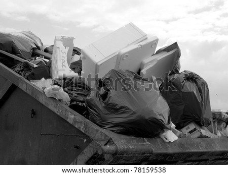 Black and white image of filled waste skip