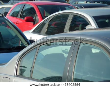Telephoto view of cars parked in parking lot. Image can be reversed for non British uses. Also useful for environmental issues.
