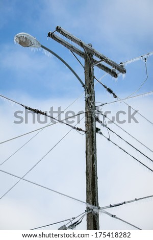 Glazed Power Line Utility Pole Electric Line from Winter Ice Snow Storm, Icicles