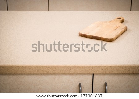 Tan kitchen counter with cutting board minimalist style