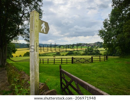 Sign post indicating a public footpath through British countryside