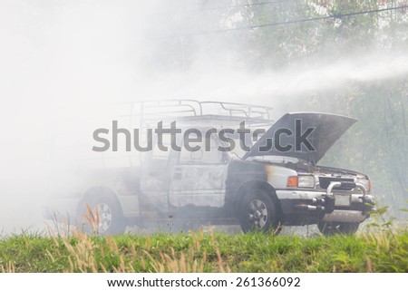 UDONTHANI-MARCH 14,2015:Car on fire after short circuit on the Highway with firefighters.Udonthani thailand 14 march 2015