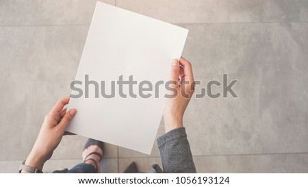 Person holding white empty paper 商業照片 © 