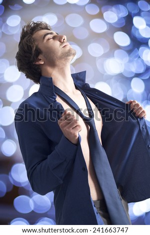 Handsome sexy man in shirt on bright background