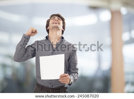 Happy businessman holding the paper