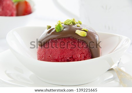 Strawberry sorbet with chocolate and pistachios.