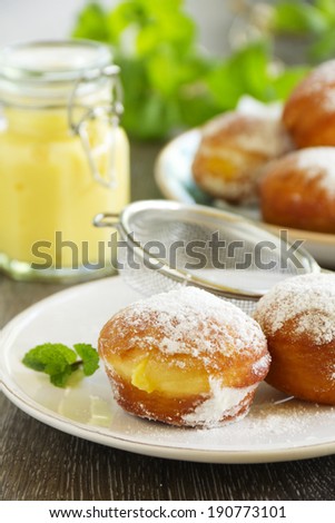 With vanilla cream donuts in powdered sugar.