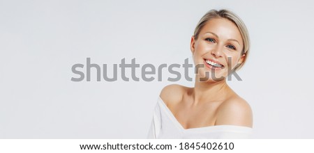 Beauty portrait of blonde smiling laughing woman 35 year clean fresh face isolated on white background, banner