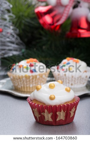 Christmas cupcakes, spruce branches and christmas bells