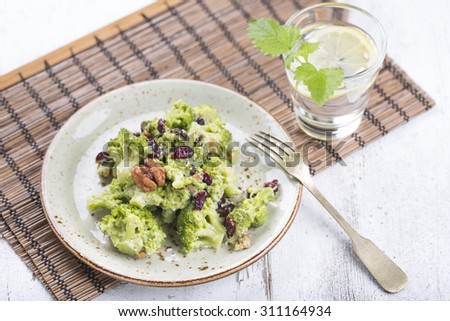 Vegan salad with broccoli, walnut and dried cherry