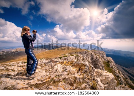 Human, who shutting mountain valley on a video camera
