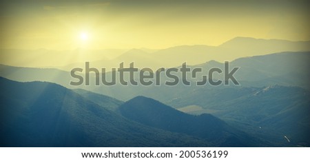 Beautiful sunrise with shining sun on a skyline in the Crimea mountains