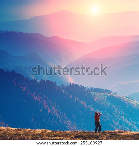 Photographer stay on a hill and shut mountain landscapes
