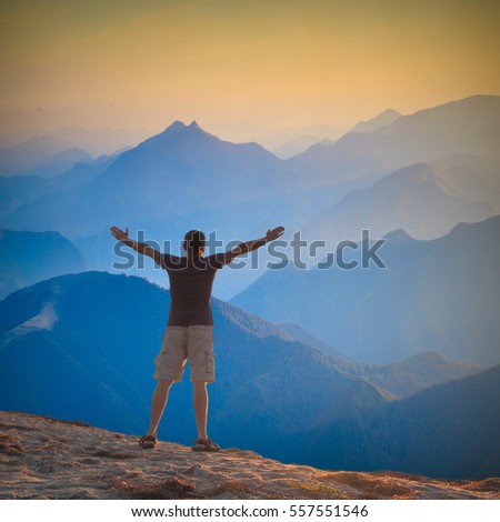 Man With Raised Hands Standing On A Mountain Hill And Welcome Sunrise ...