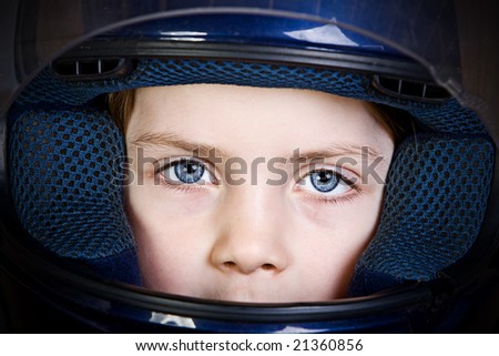 Child with Big Blue Eyes in Crash Helmet