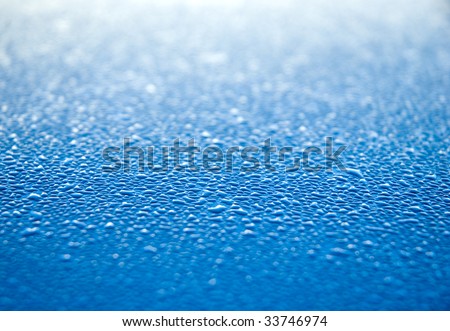 water beads on a blue surface