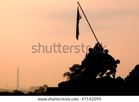 back lit Marine Corps War Memorial Iwo Jima statue and American Flag at sunrise