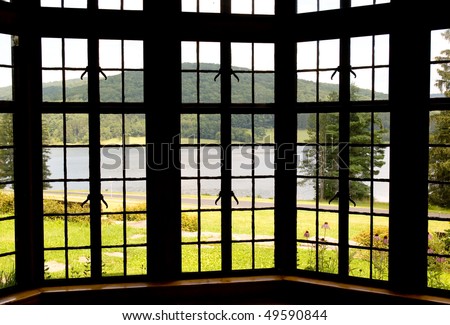 lake and forest through a bay window