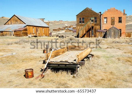 abandoned cart and ghost town buildings