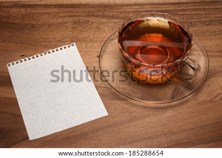 Blank paper and tea cup on wood table