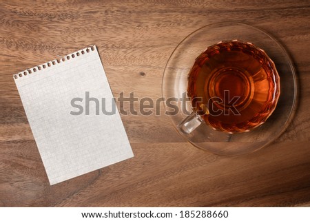 Blank paper and tea cup on wood table